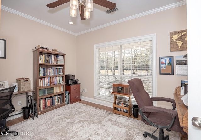 office space featuring ceiling fan, light wood-type flooring, and crown molding