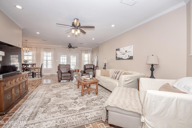 living room with ornamental molding and ceiling fan