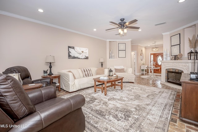 living room featuring ornamental molding, a high end fireplace, and ceiling fan