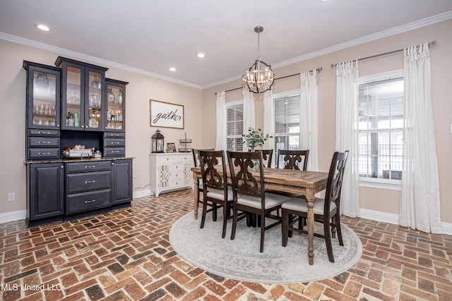 dining area featuring a chandelier and crown molding