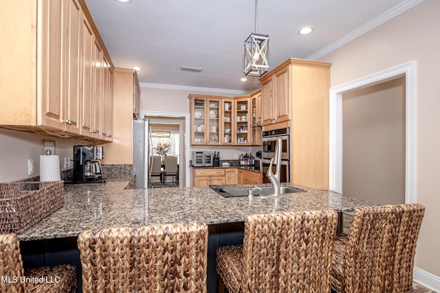 kitchen featuring stainless steel appliances, stone counters, and crown molding