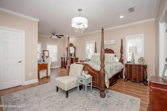 bedroom featuring crown molding and light hardwood / wood-style flooring