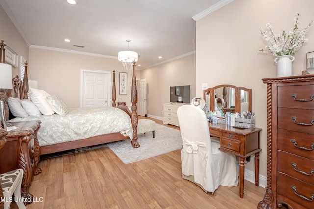 bedroom with light wood-type flooring and crown molding