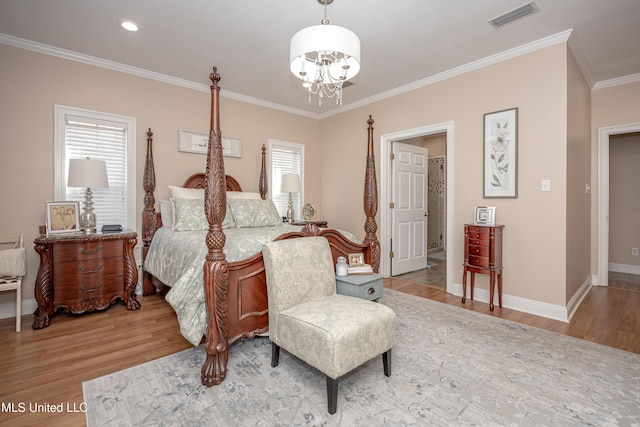 bedroom featuring a notable chandelier, crown molding, and hardwood / wood-style flooring