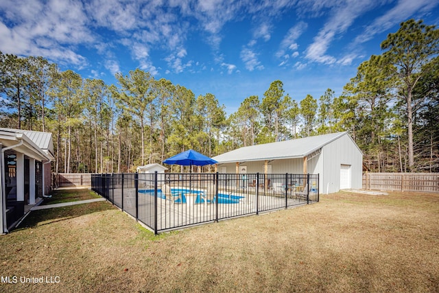 view of swimming pool with an outdoor structure and a lawn