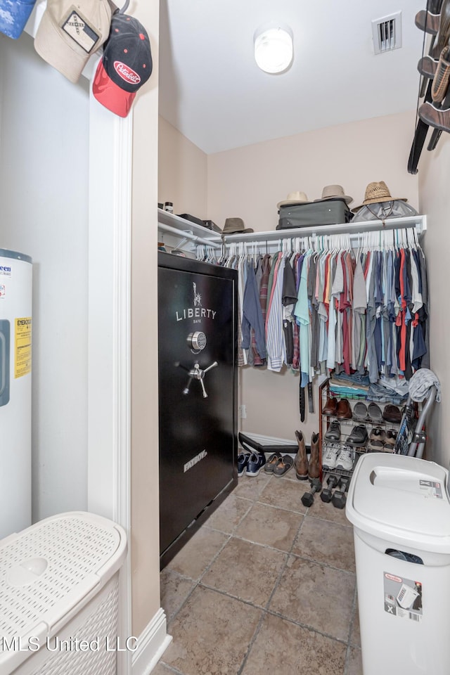 walk in closet featuring electric water heater