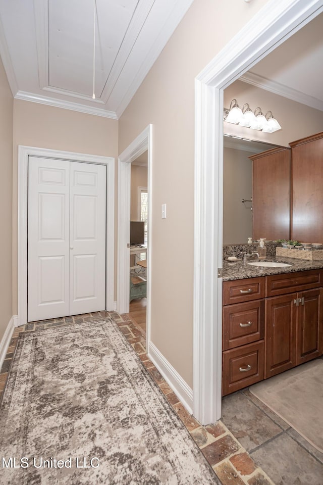 hall featuring sink and ornamental molding