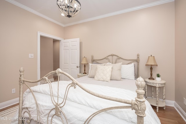 bedroom with a notable chandelier, hardwood / wood-style floors, and crown molding