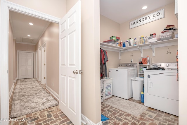 laundry area featuring ornamental molding and separate washer and dryer