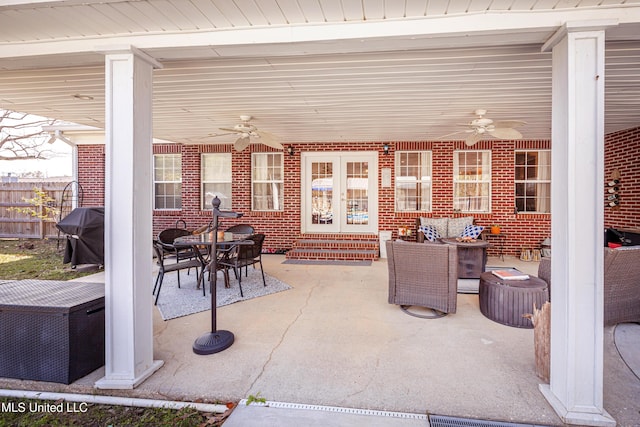 view of patio featuring ceiling fan, french doors, area for grilling, and an outdoor living space