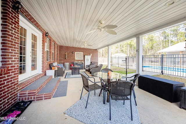 view of patio featuring ceiling fan, french doors, a fenced in pool, and an outdoor living space