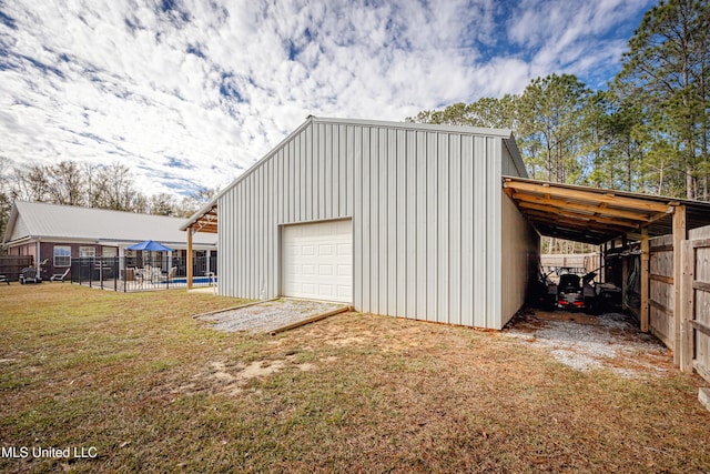 garage with a yard and a carport