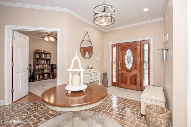 foyer entrance featuring ceiling fan with notable chandelier and crown molding