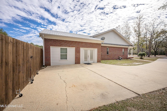 view of side of property featuring french doors and a patio area