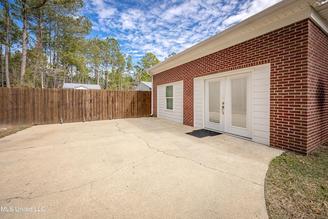 view of exterior entry featuring a patio and french doors