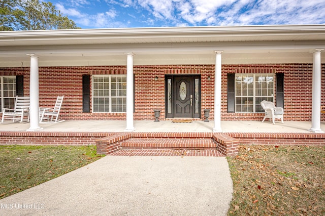 view of exterior entry with covered porch