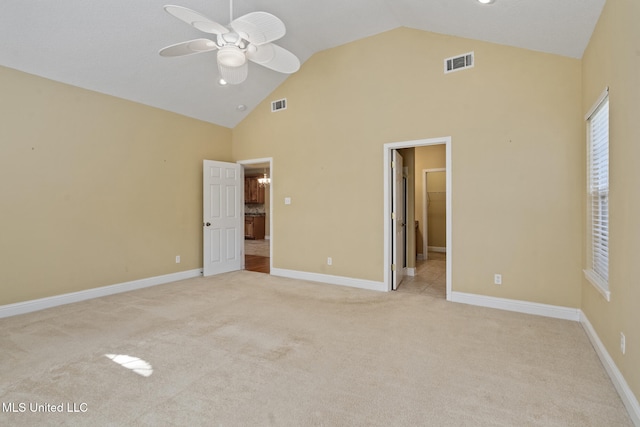 unfurnished bedroom with light carpet, high vaulted ceiling, connected bathroom, and ceiling fan