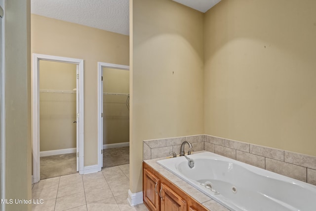 bathroom featuring a bathing tub, a textured ceiling, and tile patterned floors