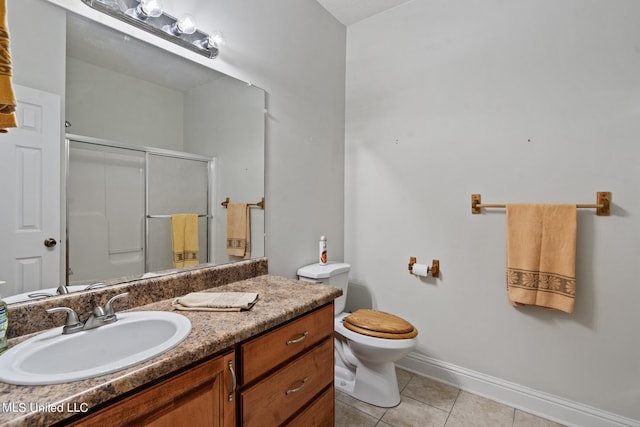 bathroom with toilet, a shower with shower door, vanity, and tile patterned flooring