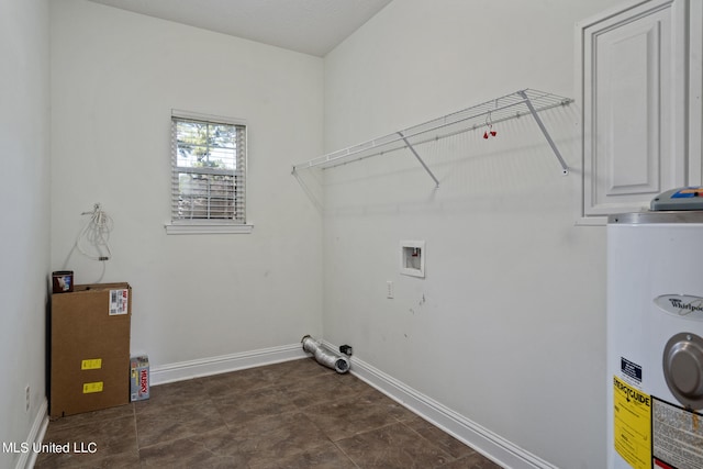 laundry area featuring water heater, dark tile patterned floors, and washer hookup