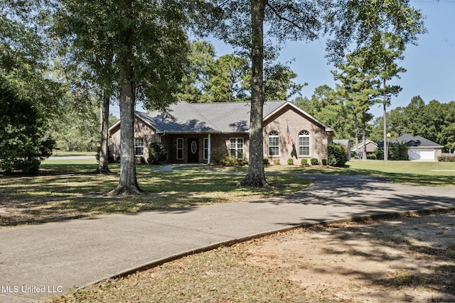 view of front of home with a front lawn and a garage