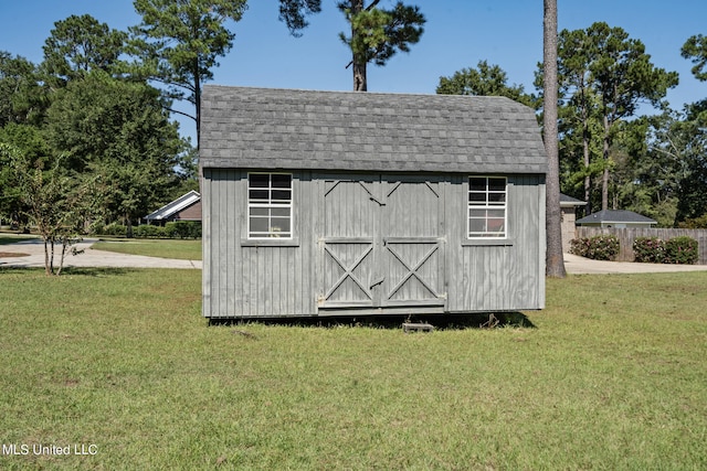 view of outbuilding featuring a yard