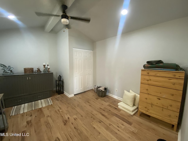 bedroom featuring a ceiling fan, wood finished floors, baseboards, a closet, and lofted ceiling