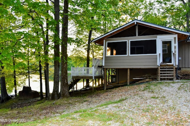 view of front of house with stairway and a deck