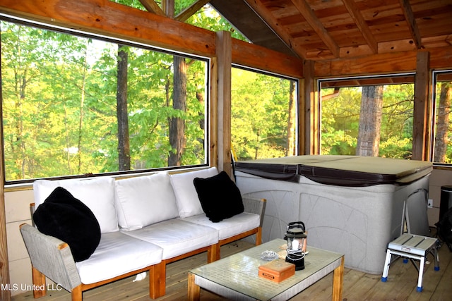 sunroom featuring vaulted ceiling with beams, a jacuzzi, hardwood / wood-style floors, and wooden ceiling
