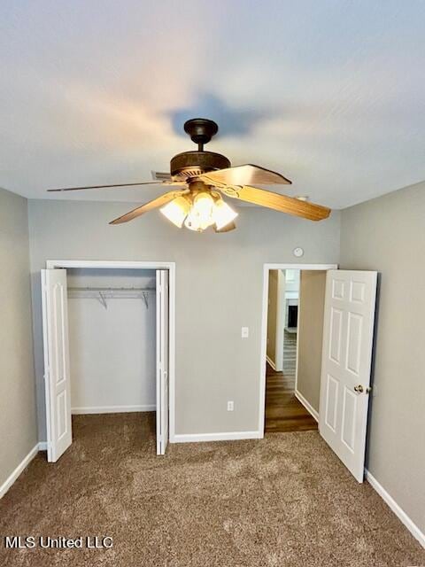 unfurnished bedroom featuring a closet, ceiling fan, and dark colored carpet