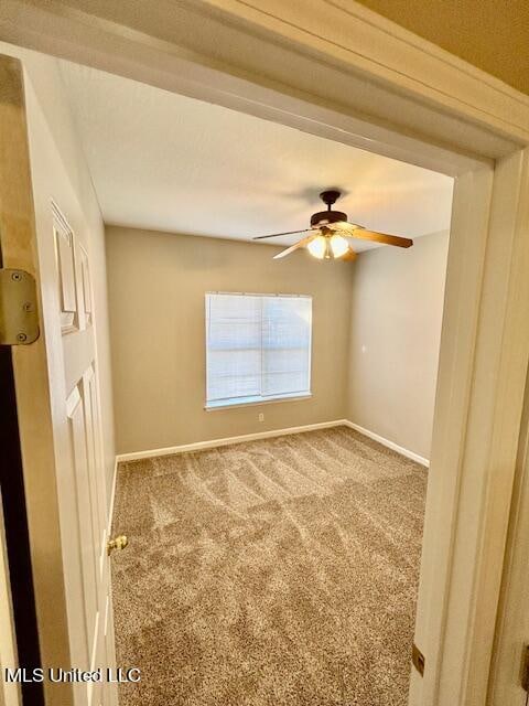 carpeted empty room with ceiling fan