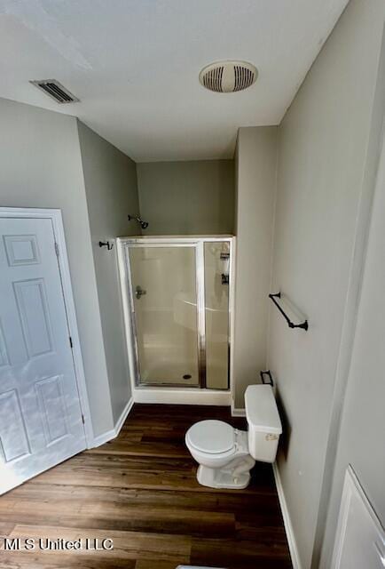 bathroom with toilet and wood-type flooring