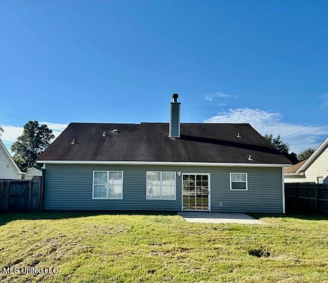 back of property featuring a patio area and a yard