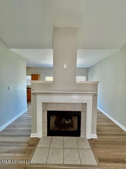 room details with wood-type flooring and a tile fireplace