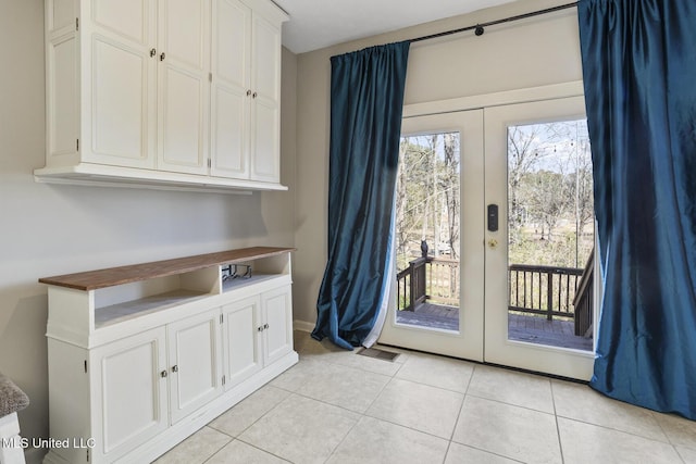 entryway with french doors and light tile patterned flooring