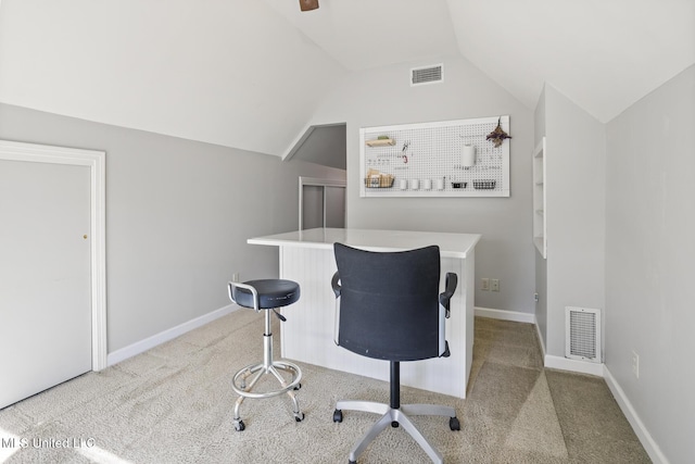 office area featuring vaulted ceiling and light carpet