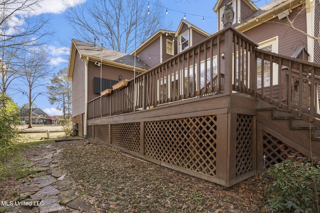 back of property with a wooden deck