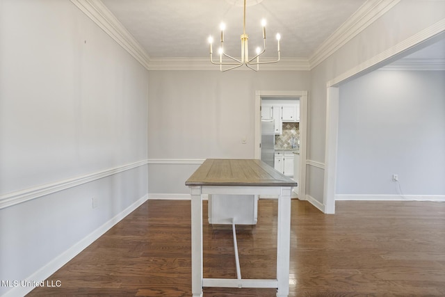 unfurnished dining area with dark wood-type flooring, crown molding, and a chandelier