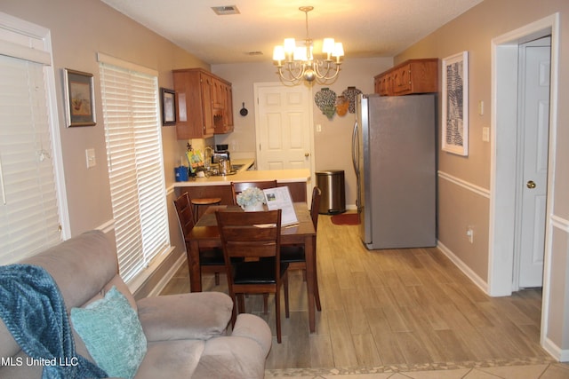 100 Roseleigh Cv, Batesville, MS 38606 - dining room with a chandelier and light wood finished floors