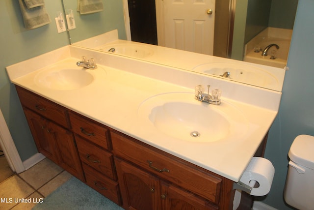 100 Roseleigh Cv, Batesville, MS 38606 - bathroom featuring double vanity, tile patterned flooring, and a tub to relax in