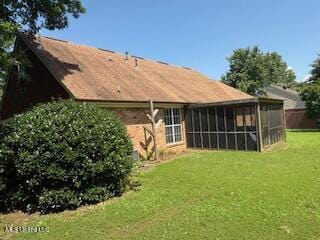 100 Roseleigh Cv, Batesville, MS 38606 - back of house featuring a yard and a sunroom