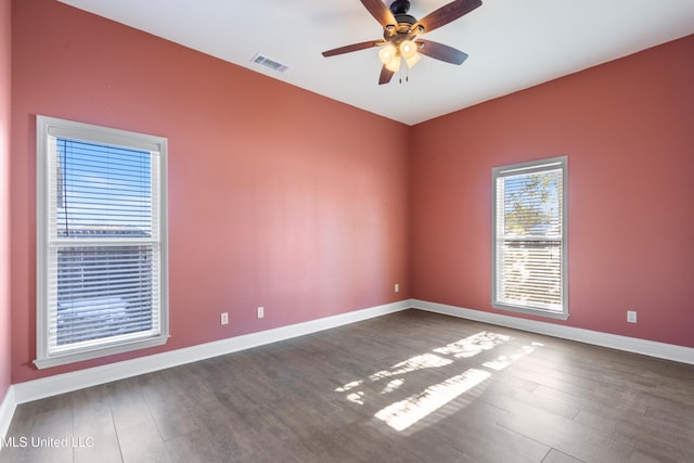 empty room featuring ceiling fan and dark hardwood / wood-style flooring