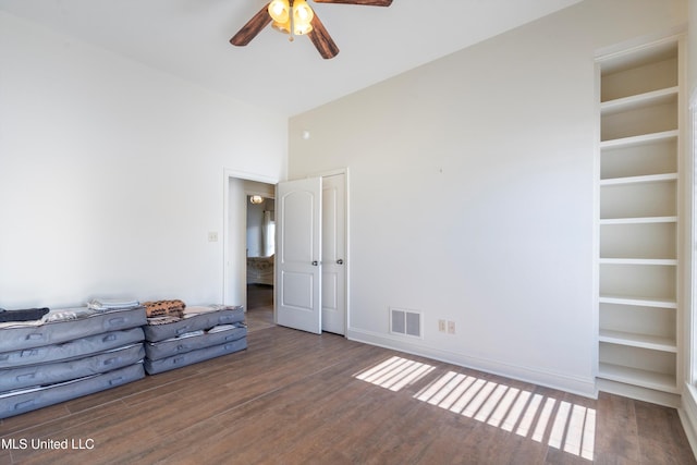 unfurnished bedroom featuring ceiling fan and dark hardwood / wood-style flooring