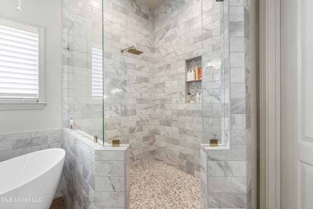 bathroom with separate shower and tub and tile walls