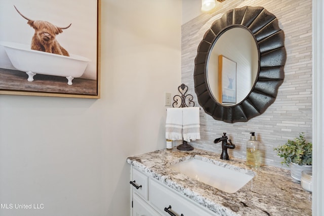 bathroom with decorative backsplash and vanity