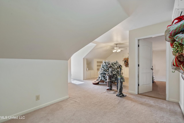 additional living space featuring light carpet, ceiling fan, and lofted ceiling