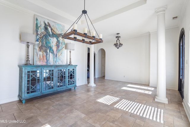 unfurnished living room with crown molding and decorative columns