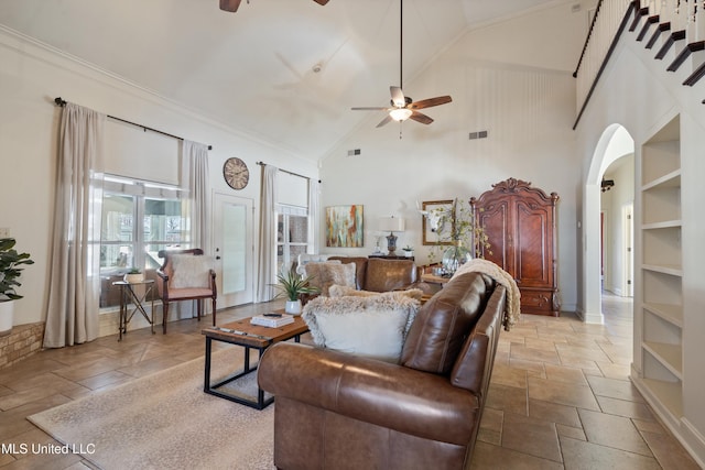 living room with ceiling fan and high vaulted ceiling