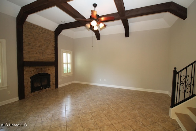 unfurnished living room featuring beamed ceiling, a fireplace, and ceiling fan