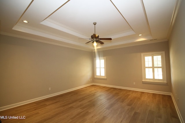 unfurnished room featuring crown molding, hardwood / wood-style floors, ceiling fan, and a raised ceiling